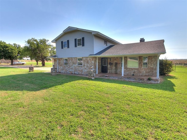 rear view of property with a lawn