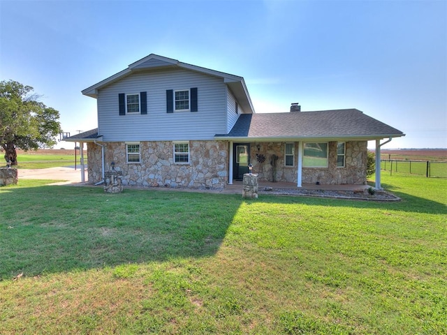 rear view of house with a yard