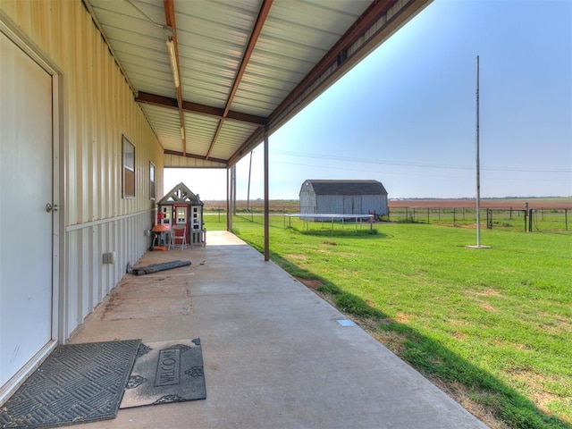 view of patio featuring a rural view and a trampoline