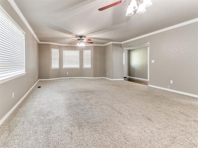 carpeted empty room with ceiling fan and ornamental molding