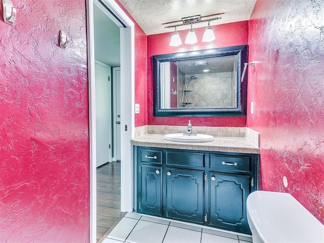 bathroom featuring tile patterned floors, vanity, and toilet