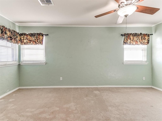 carpeted empty room featuring ceiling fan and ornamental molding