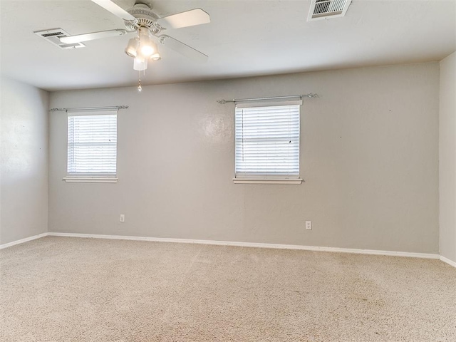 empty room with ceiling fan and carpet floors