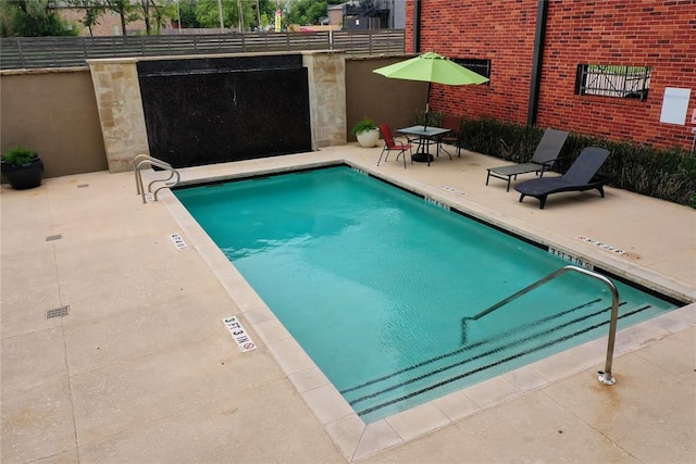 view of swimming pool with a patio area