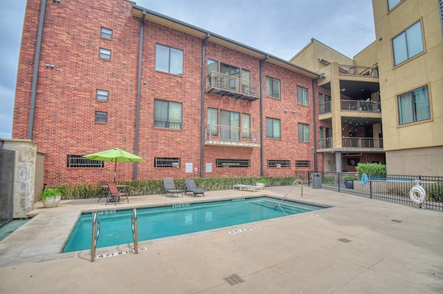 view of pool featuring a patio and cooling unit