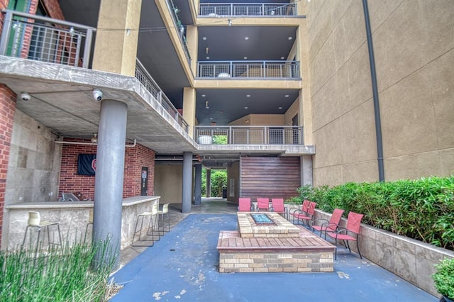 view of patio / terrace with an outdoor bar and an outdoor fire pit