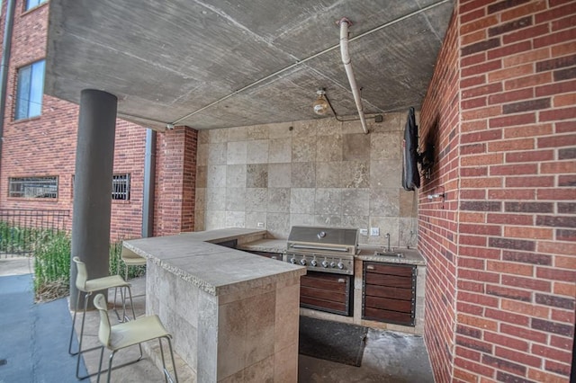 view of patio with area for grilling, sink, and grilling area