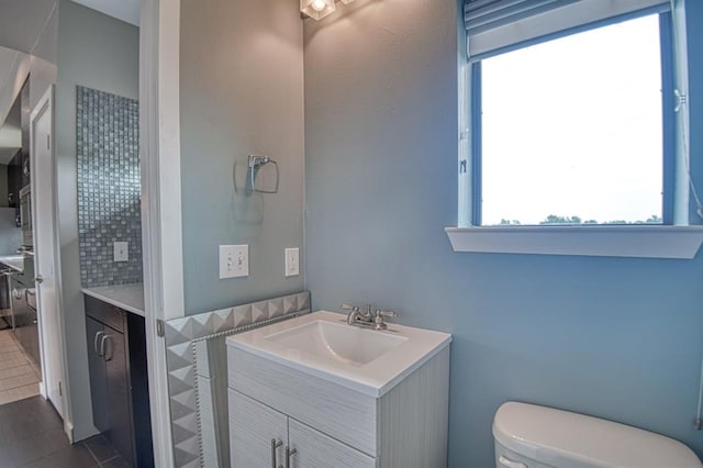 bathroom with tile patterned floors, vanity, and toilet