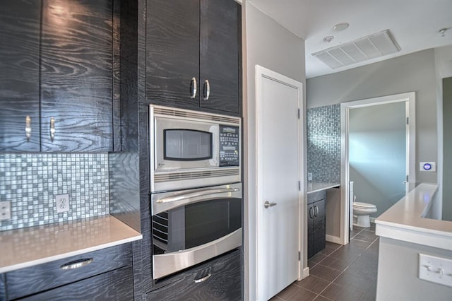 kitchen featuring dark tile patterned floors and stainless steel appliances