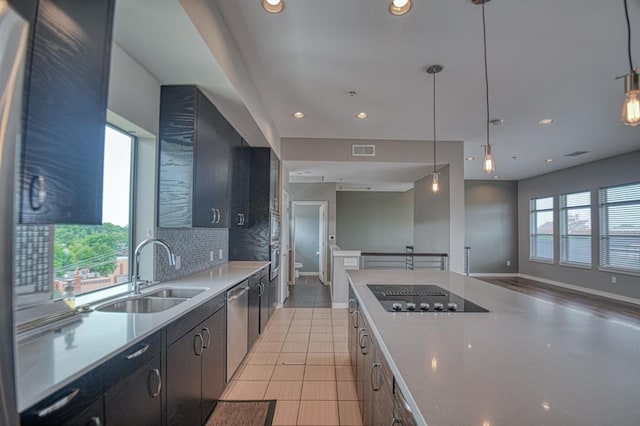 kitchen featuring pendant lighting, plenty of natural light, and sink