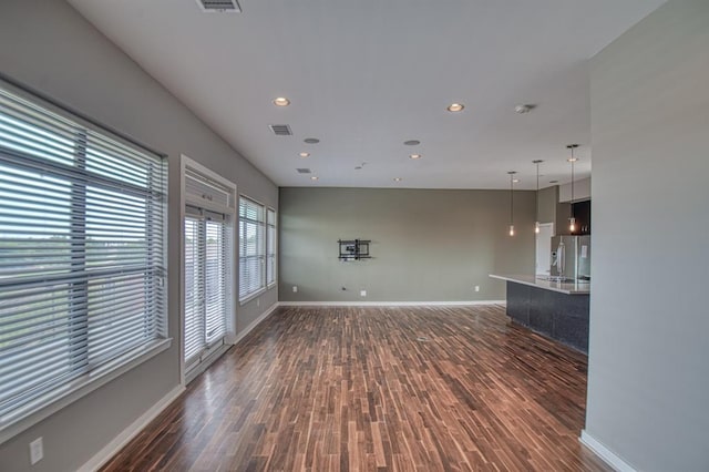 unfurnished living room with dark hardwood / wood-style floors