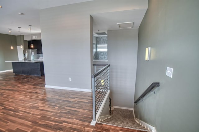 staircase with wood-type flooring