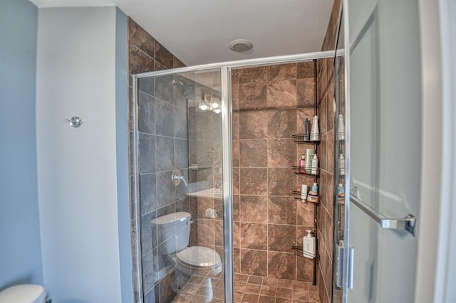 bathroom featuring walk in shower and toilet