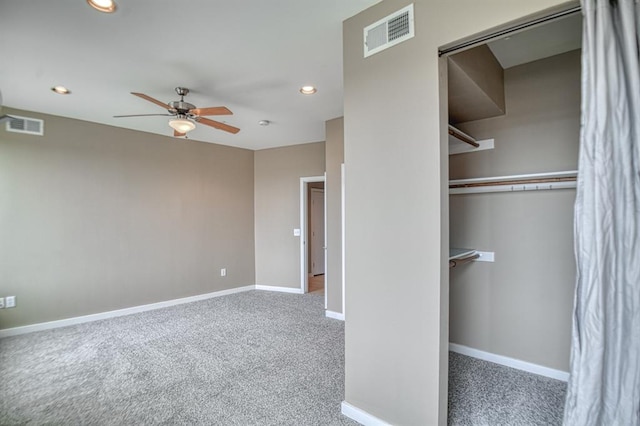 unfurnished bedroom featuring carpet flooring, ceiling fan, and a closet