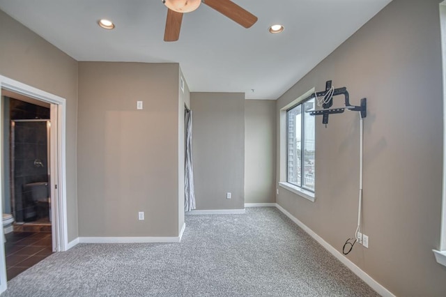 unfurnished bedroom with ceiling fan, carpet floors, and connected bathroom