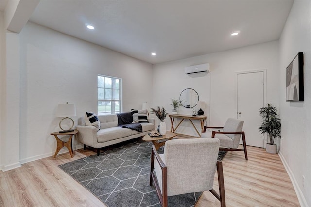 living room with a wall mounted air conditioner and hardwood / wood-style floors