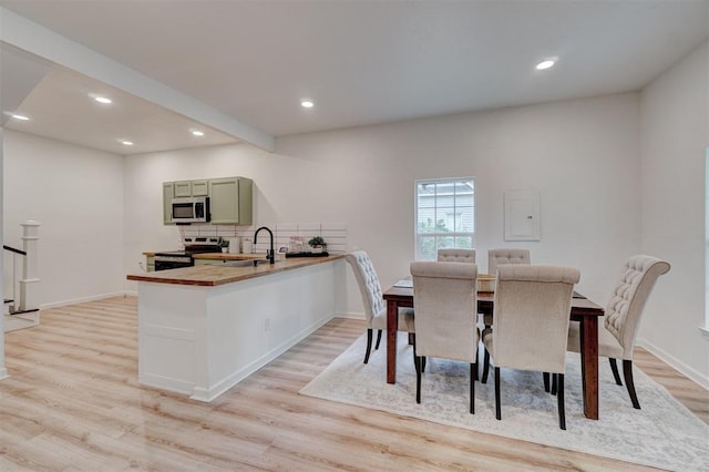 dining area featuring light hardwood / wood-style floors and sink