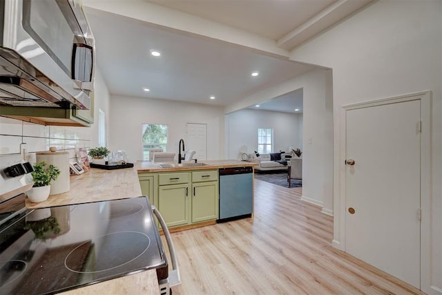 kitchen featuring dishwasher, green cabinets, sink, a wealth of natural light, and range