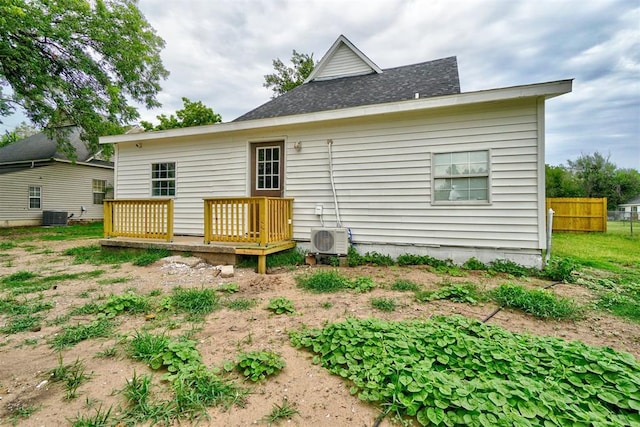 back of property with ac unit and central AC