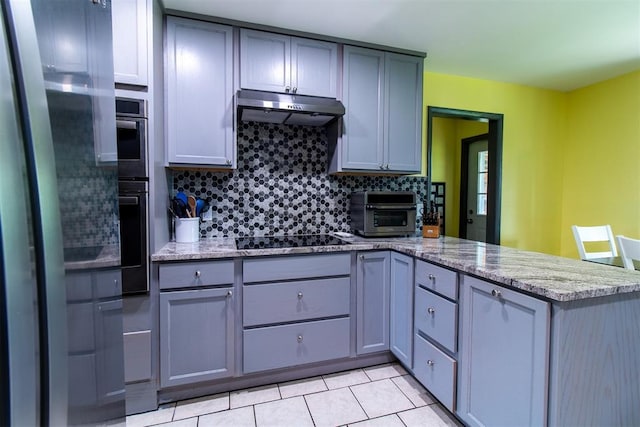 kitchen featuring light stone countertops, kitchen peninsula, gray cabinets, light tile patterned floors, and black appliances