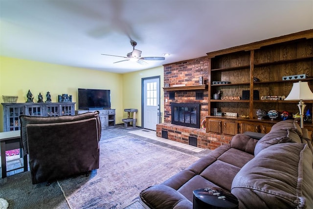 living room featuring carpet flooring, ceiling fan, and a fireplace