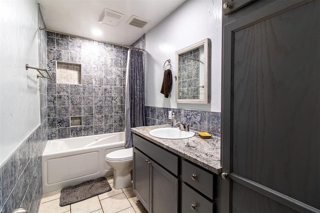 full bathroom with tile patterned floors, shower / tub combo with curtain, tile walls, and toilet