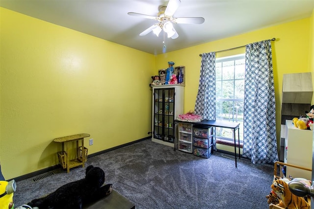 miscellaneous room featuring ceiling fan and dark carpet