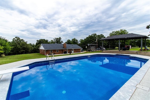 view of swimming pool featuring a gazebo, a diving board, and a lawn