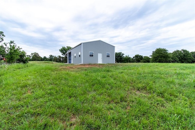 view of yard featuring an outbuilding and a rural view