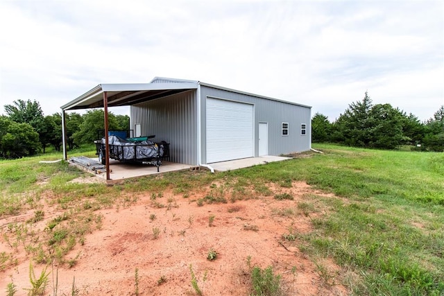 view of outdoor structure with a lawn and a garage