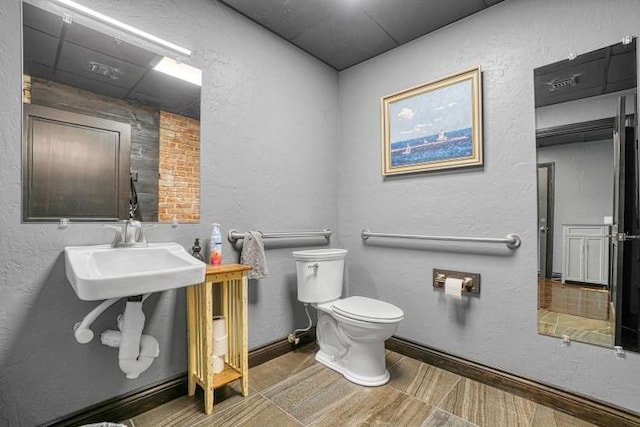 bathroom with tile patterned flooring, toilet, and sink