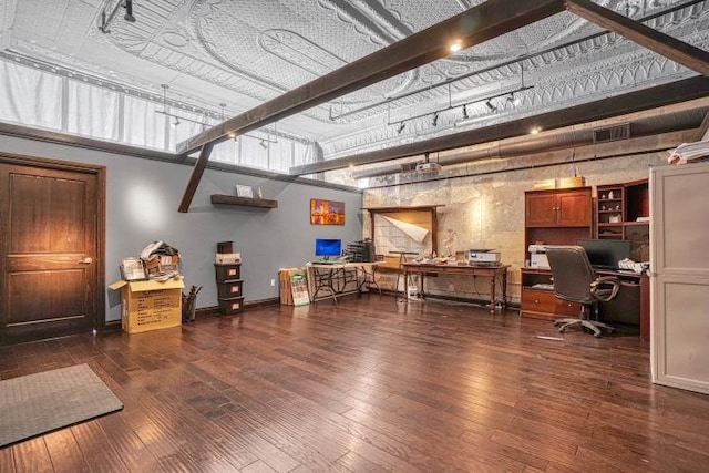 office area with beamed ceiling and dark hardwood / wood-style floors