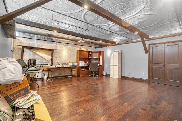 miscellaneous room featuring beamed ceiling and dark hardwood / wood-style floors