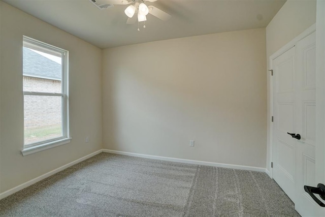 unfurnished room featuring ceiling fan and carpet floors