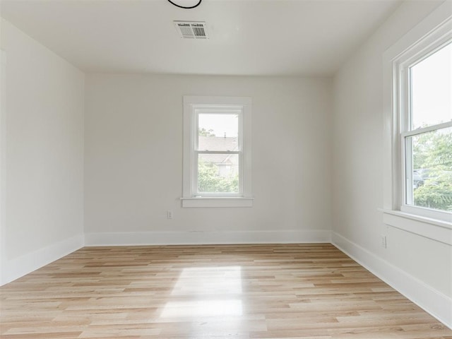 empty room with light hardwood / wood-style flooring