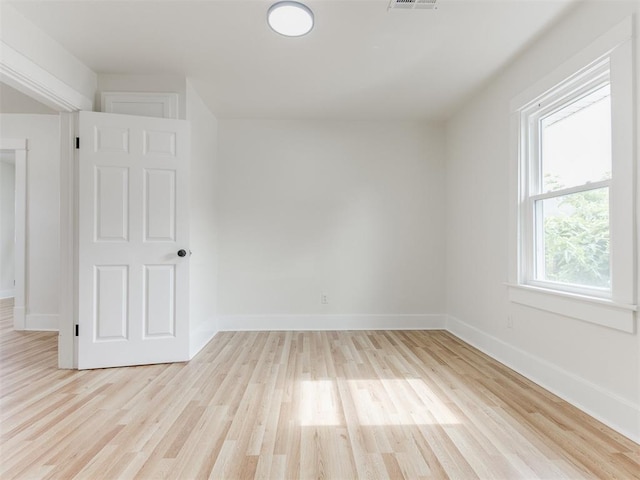 unfurnished room with light wood-type flooring