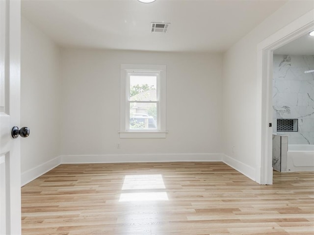 spare room featuring light wood-type flooring