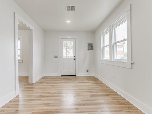 entryway with electric panel and light wood-type flooring