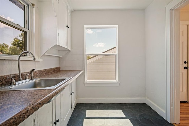 kitchen with white cabinets, dark hardwood / wood-style floors, and sink