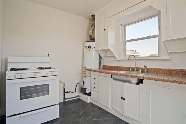 kitchen with sink, gas water heater, tasteful backsplash, white range with gas stovetop, and white cabinets