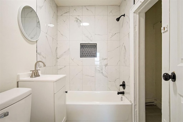 full bathroom with toilet, vanity, and tiled shower / bath