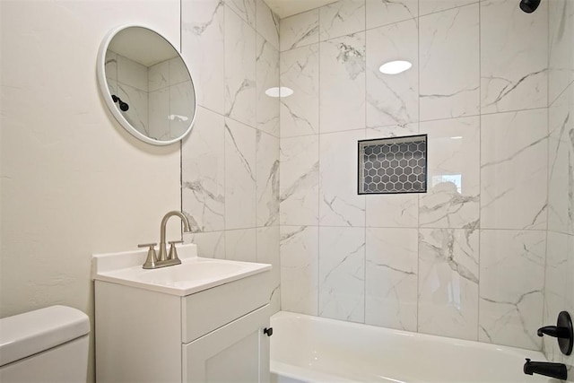 full bathroom with vanity, toilet, and tiled shower / bath