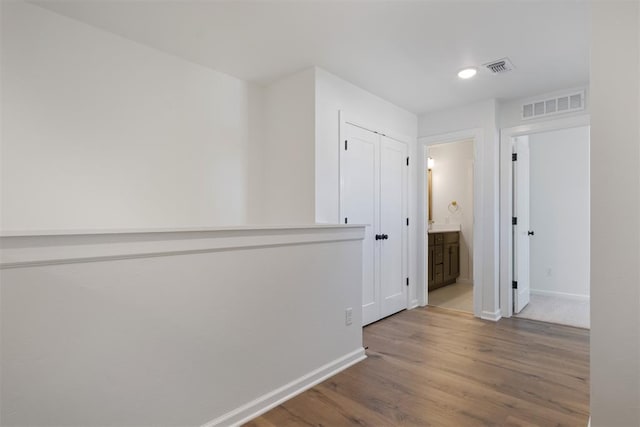 hall with hardwood / wood-style floors