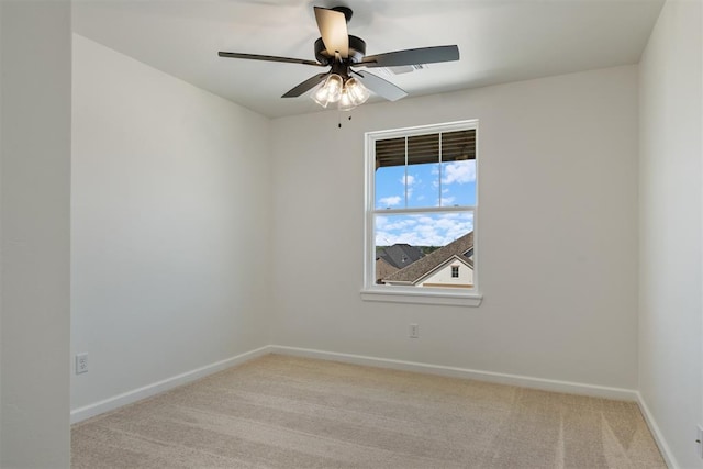 carpeted spare room with ceiling fan