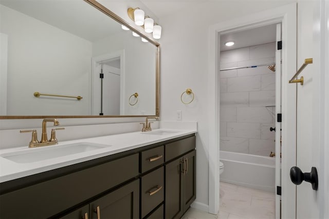 full bathroom with vanity, toilet, and tiled shower / bath combo