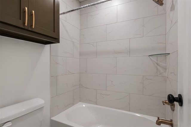 bathroom featuring toilet and tiled shower / bath