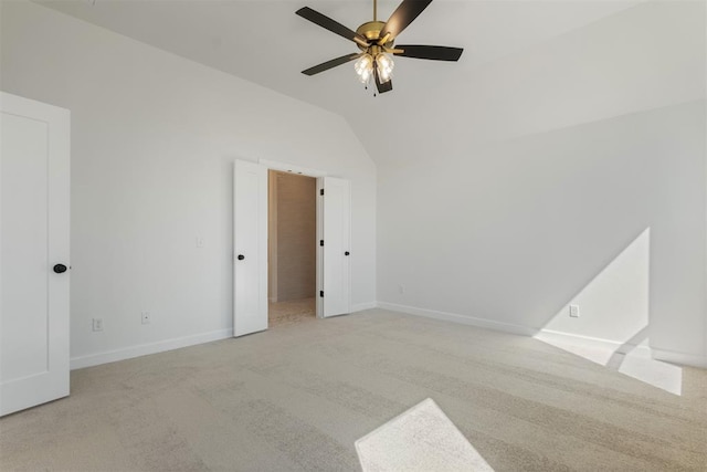 carpeted empty room with ceiling fan and lofted ceiling