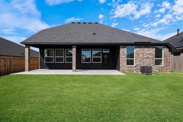 rear view of house featuring a patio area, a yard, and central air condition unit