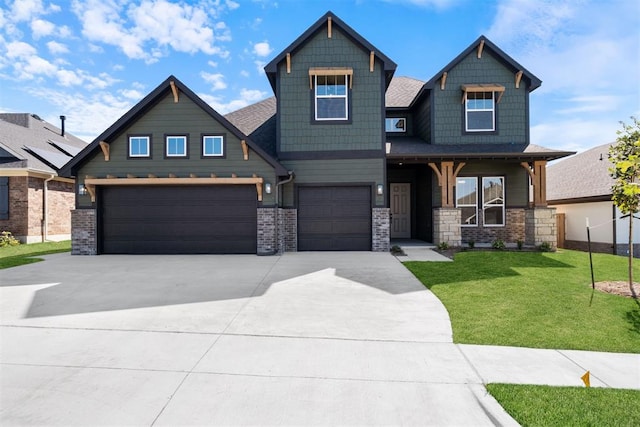 craftsman inspired home featuring a garage and a front yard