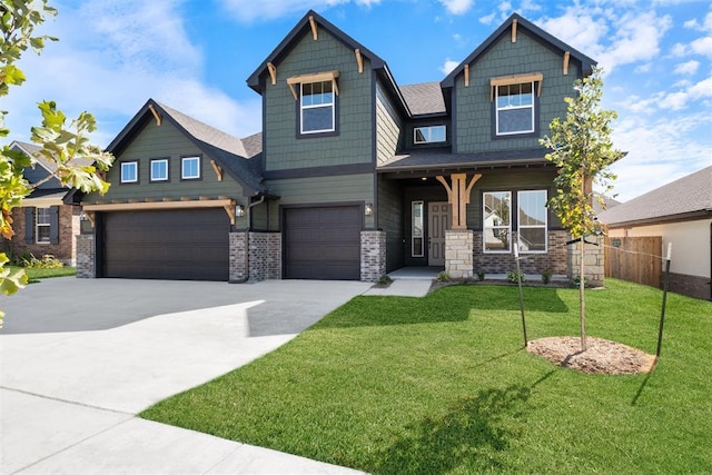 craftsman inspired home with covered porch, a front yard, and a garage